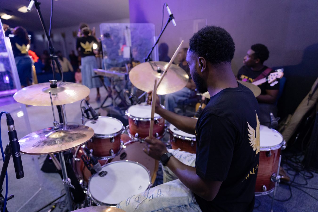 Drummer performing with full band