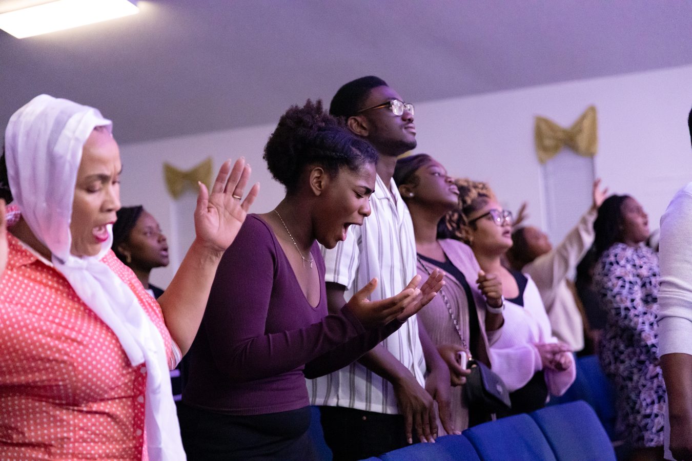 Congregation in worship hands raised